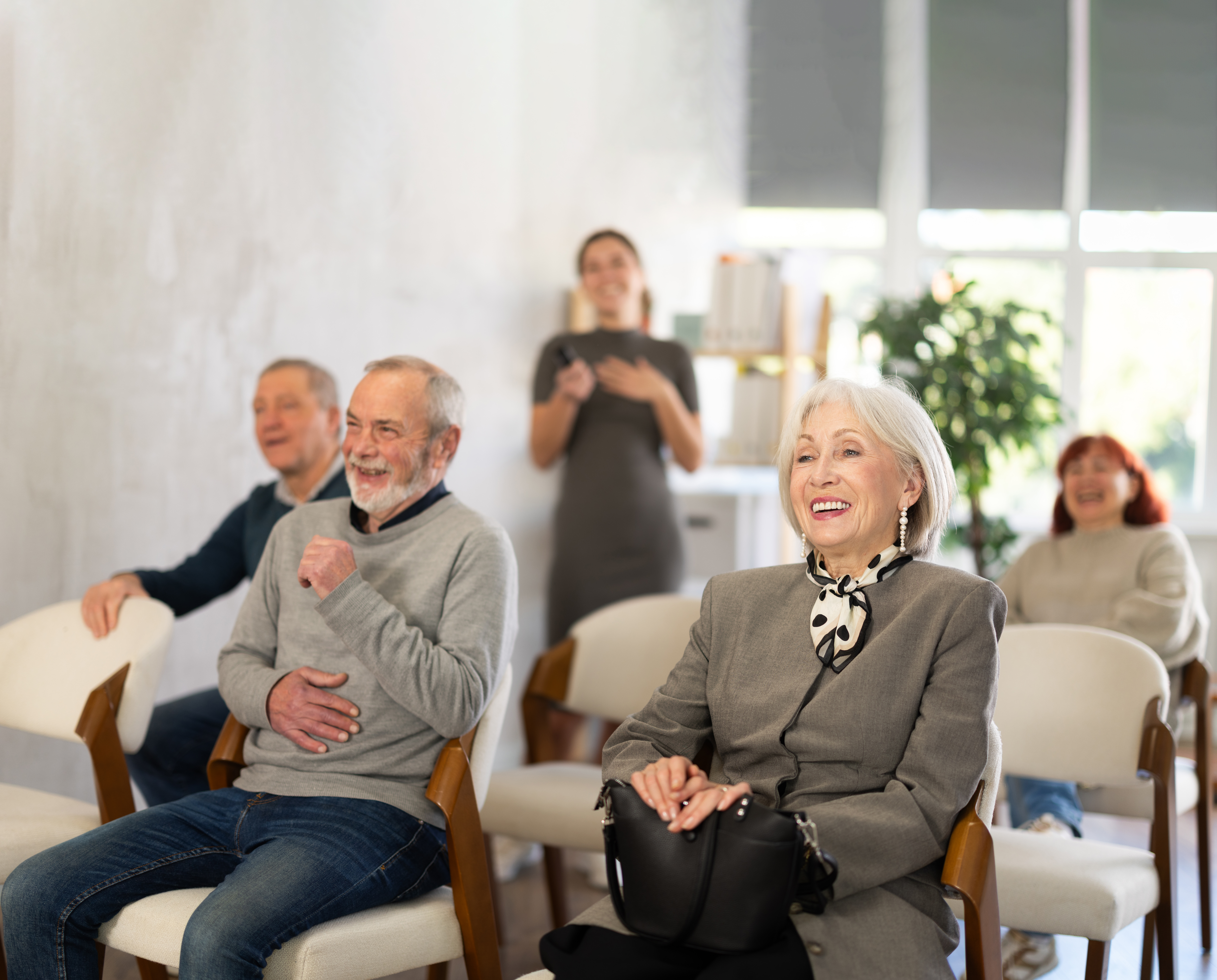 Older adults seated at a senior living community presentation during a Meet & Greet event about planning future care options.